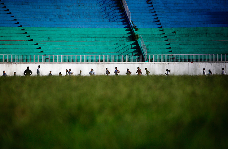 24 hours in pictures: Athletes run on the track at Dasarath Rangasala stadium, Kathmandu, Nepal