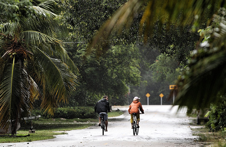 Tropical Storm Isaac: People ride bikes as as Tropical Storm Isaac in Marathon, Florida