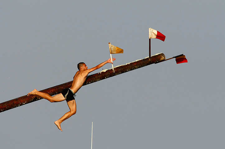 24 hours in pictures: A competitor grabs a flag as he slips off the 