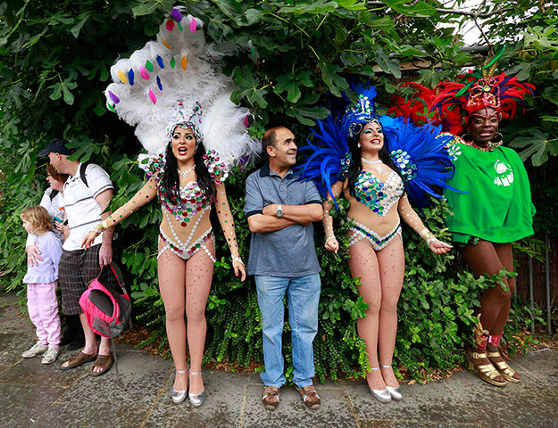 Notting Hill Carnival: Performers and spectators shelter from the rain