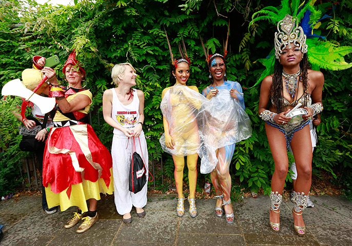 Notting Hill Carnival: Performers shelter from the rain