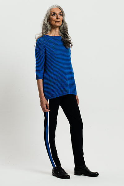 All Ages: Blue: Model wears blue jumper and black trousers with a blue stripe