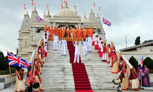 Torchbearing team 056 Barrie Guy, Antony Eames, and others outside the Shri Swaminarayan Mandir temple in Neasden, as they carry the Paralympic Flame during the Torch Relay leg through Brent