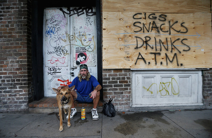 Tropical storm Isaac: Homeless man by a boarded up store in the French Quarter