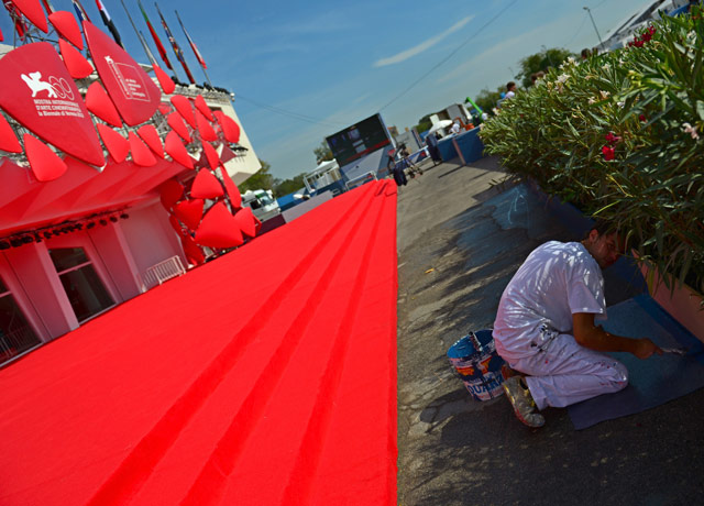 Venice 2012 day 1: A worker puts the last touch of paint ne