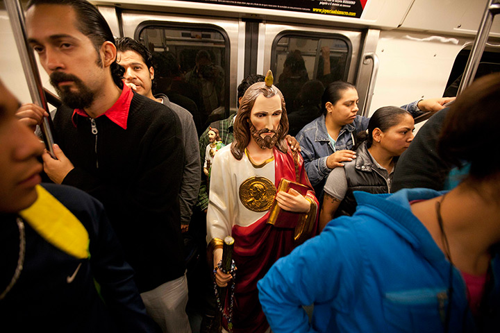 24 hours: Mexico City, Mexico: A large statue of Saint Jude stands in a metro train