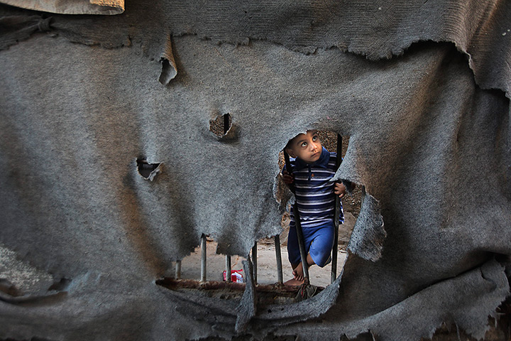 24 hours: Gaza Strip: A Palestinian refugee boy stands in Jabaliya refugee camp 