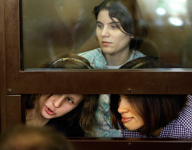 Pussy Riots: Pussy riots members peer through the glass window where they are detained