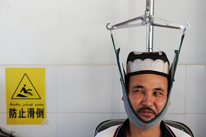 24 hours in pictures: An ethnic Uighur resident receives traditional Chinese medical treatmen