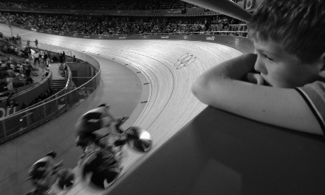 A young boy watches the Men's team pursuit finals at the Velodrome