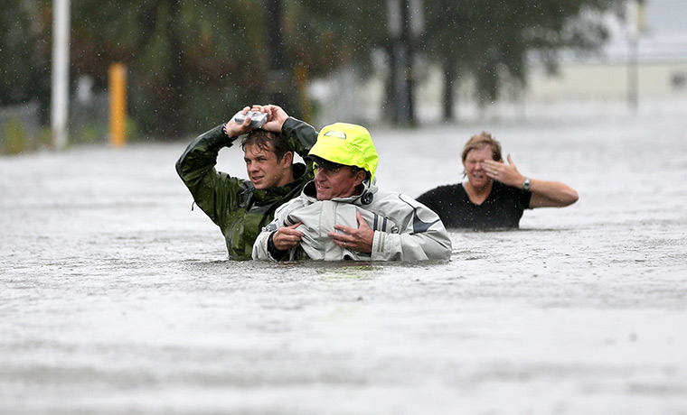 Hurricane Isaac: Chuck Cropp wade through floodwater in New Orleans