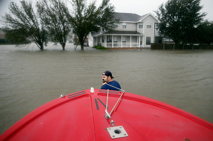 Hurricane Isaac: Man pulls his boat through deep water while rescuing residents in LaPlace