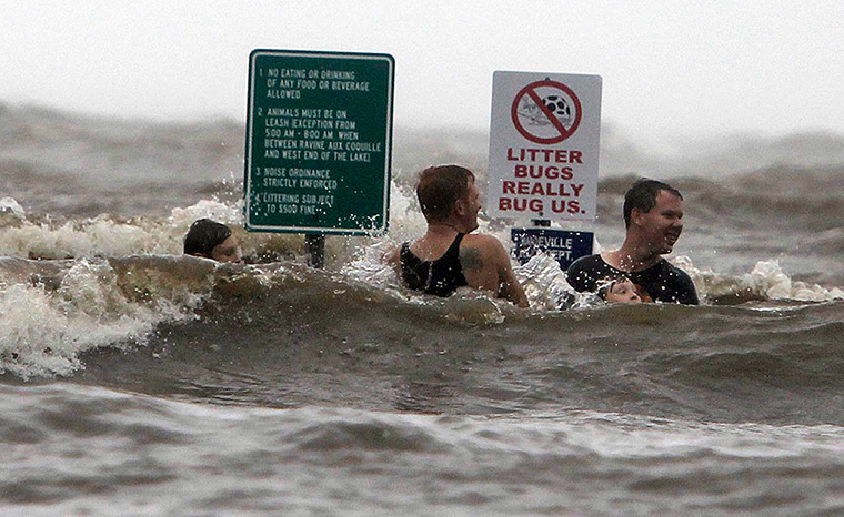 Hurricane Isaac: People in the high surf on the Lake Pontchartrain lakefront in Mandeville