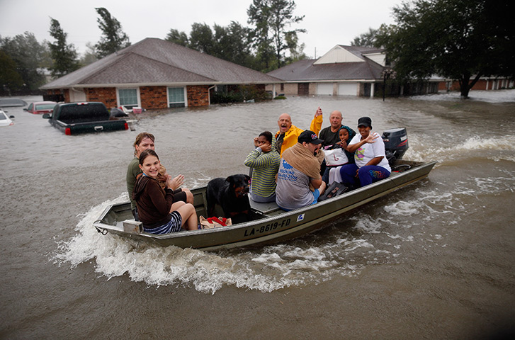 Hurricane Isaac: Rescue workers transport residents trapped by rising water in LaPlace