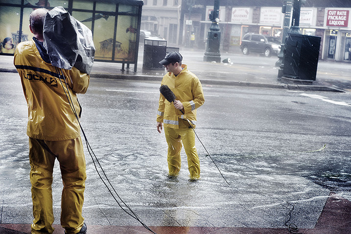 Hurricane Isaac: A news reporter stands in the rain with camera crew
