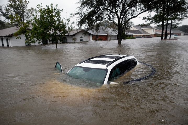 Hurricane Isaac: A car sits submerged in the flood waters in LaPlace