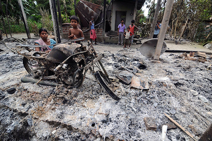 24 hours: Kharabari Charak Math, India: Residents stand by the remains of their house