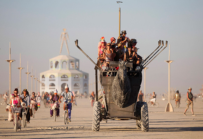24 hours: Nevada, USA: Participants ride an art car during the Burning Man