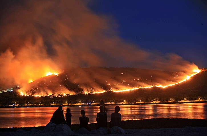 24 hours: Ciovo, Croatia: People watch the hillsides ablaze with wildfires 