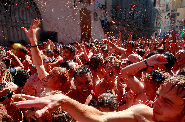 24 hours: Bunol, Spain: Revellers throw tomatoes during the annual tomatina 