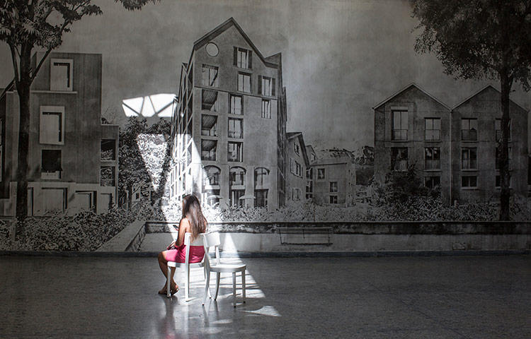Venice architecture: A visitor sits in a shard of light in the Swiss Pavillion