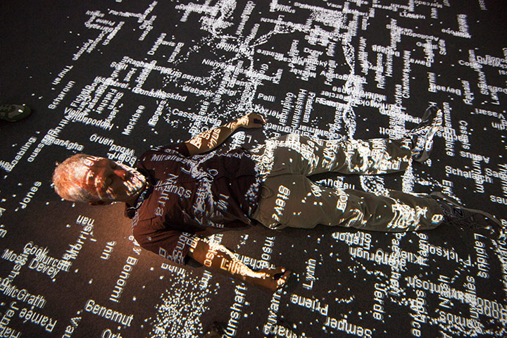 Venice biennale: A man lies down in amongst projections