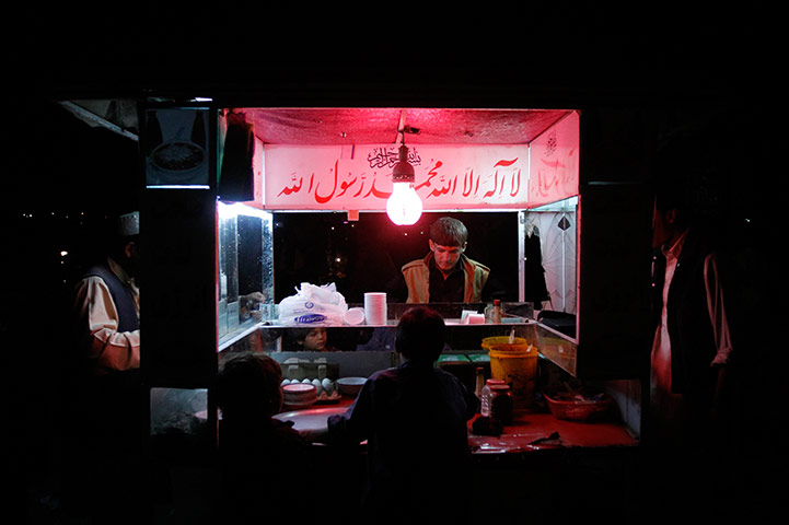 24 Hours: Kabul, Afghanistan: A young boy sells chicken soup