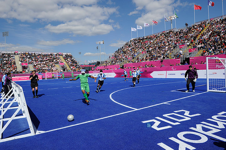 blind football: An Iranian player chases to keep the ball in play