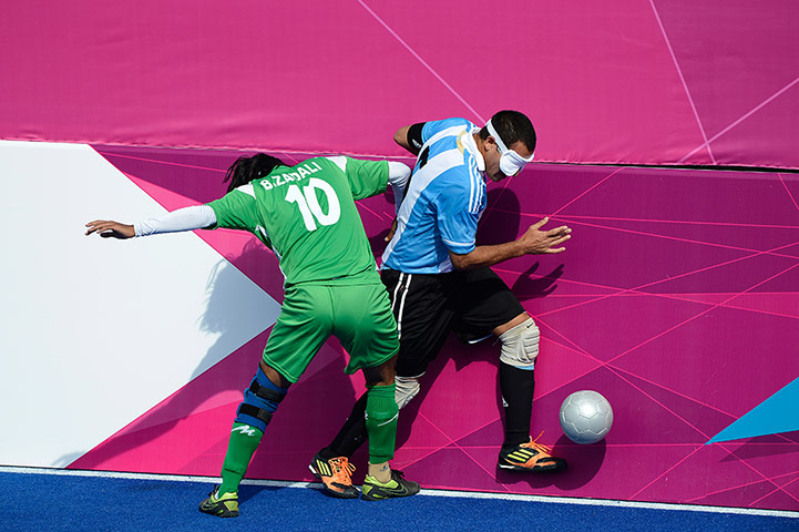 blind football: Argentina's Silvio Velo skips past Behzad Zadali of Iran