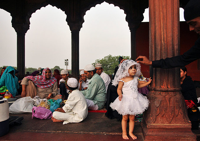24 hours: A man adjusts the veil of a young girl in New Delhi