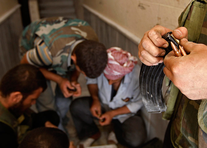 Aleppo: Free Syrian Army fighters reload rifle magazines