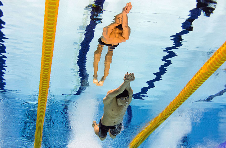 Reflections of swimming: United States's Michael Phelps  - Men's 100m butterfly