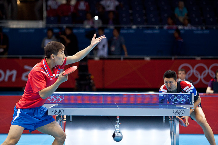 Table tennis: Hyok Bong Kim serves to a forcussed Sangeun Oh