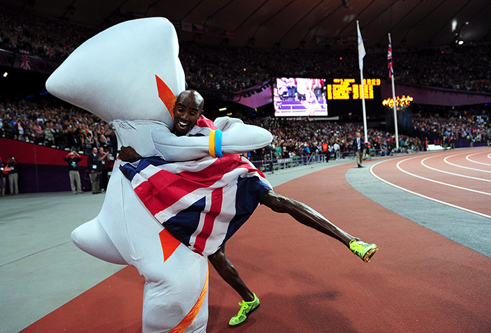 Mo Farah: Mo is engulfed by a hug from the Olympic mascot