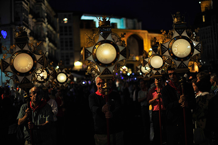 24 hours: Vitoria, Spain: People hold candles as they march in a procession