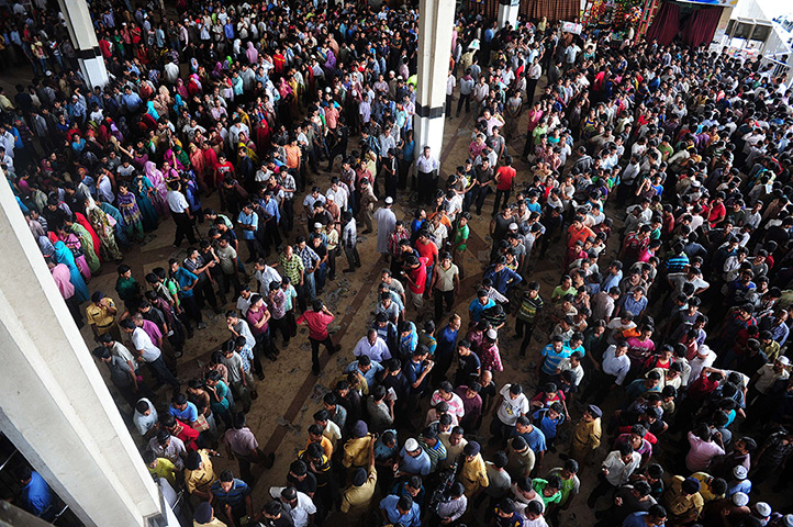 24 hours: Dhaka, Bangladesh: Travellers queue to collect tickets at a railway station