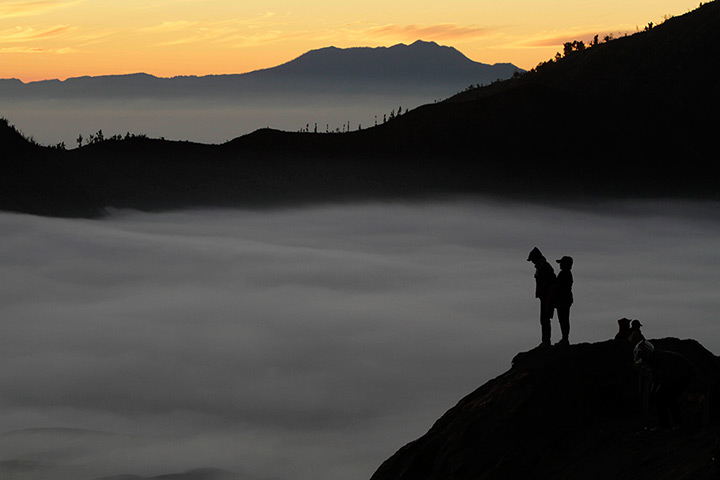 Mount Bromo: Villagers stand on a crater of Mount Bromo as they wait for sunrise 