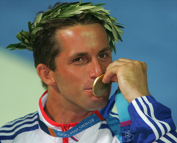 Ben Ainslie: Ben Ainslie kisses his gold medal after his win in the Finn at Athens 2004 