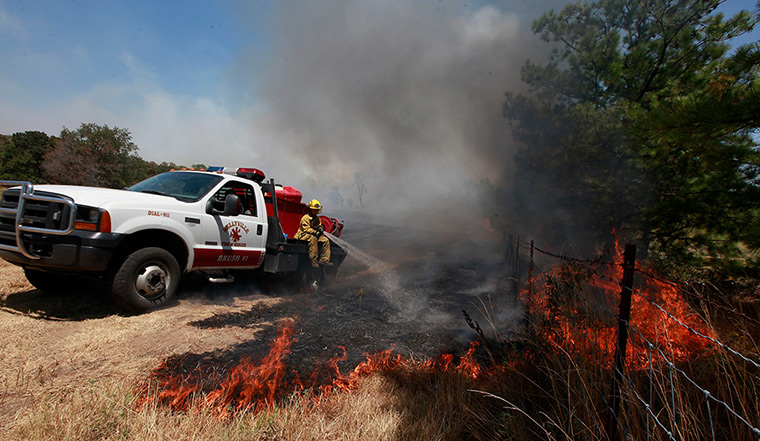 Oklahoma wildfires: A firefighter fights a grassfire in Kellyville