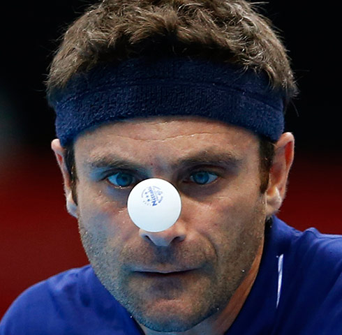 London 2012 Table Tennis: Kalinikos Kreanga serves to Jean-Michel Saive in their table tennis match 