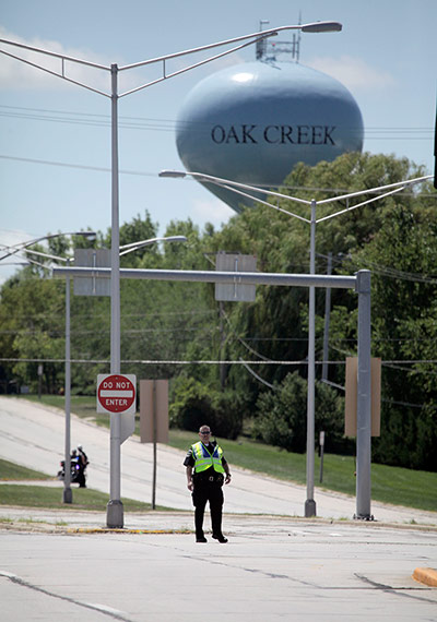 Sikh Temple Shooting USA: Police block an intersection near the Sikh Temple on S. Howell Ave. 