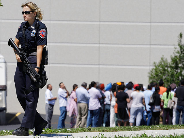 Sikh Temple Shooting USA: Police stand guard as bystanders watch at the scene of the shooting