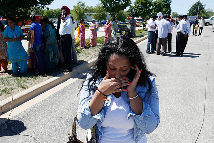 Sikh Temple Shooting USA: A woman reacts with others awaiting word on a shooting at a Sikh temple