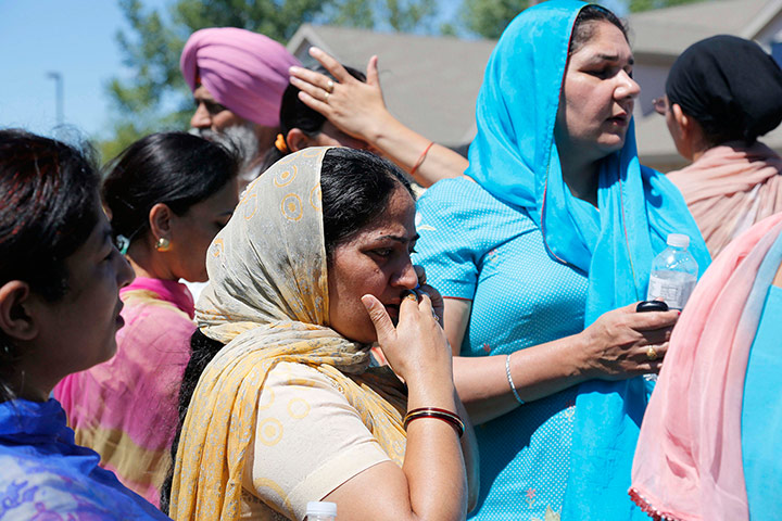 Sikh Temple Shooting USA: Bystanders stand outside the scene of a shooting inside the Sikh temple