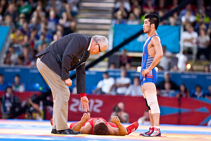 Greco Roman wrestling: Choi Gyujin of South Korea stands over Alexei Bel of Cuba