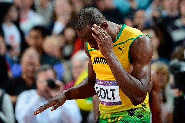 Bolt's Ticks: Usain Bolt dances prior to taking the start of the men's 100m final