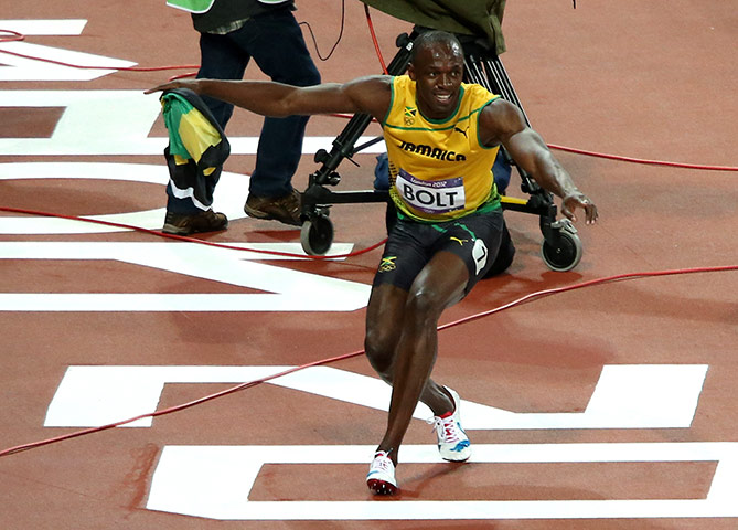 Bolt's Ticks: Bolt celebrates winning the 100m final