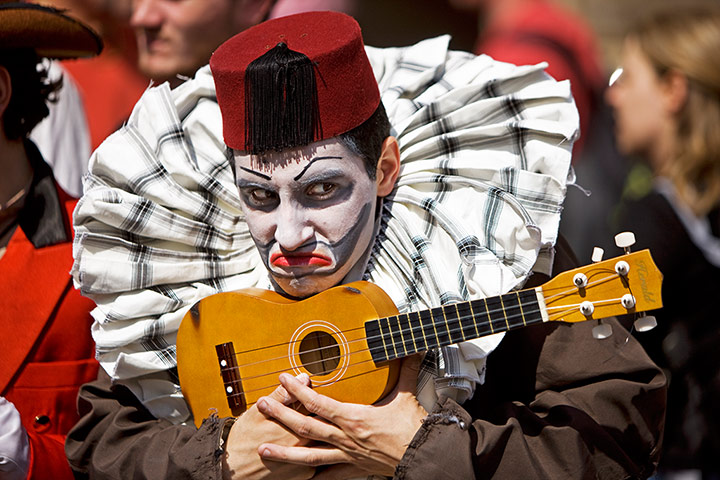 Royal Mile: A clown from the The Fourth Monkey Theatre Company jostles with the crowd