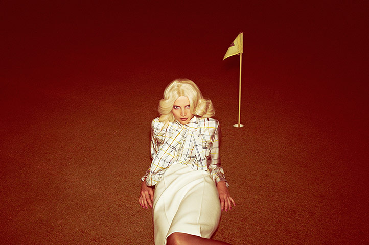 Fashion: Summer Evening: Model wearing yellow and black striped white blouse and a white skirt