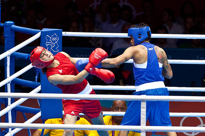 Women's boxing: Morocco's Mahjouba Oubtil evades the left of Brazil's Adriana Araujo